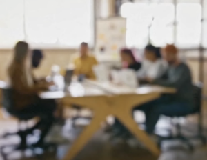 A picture of attorneys meeting around a table in conference, blurred 